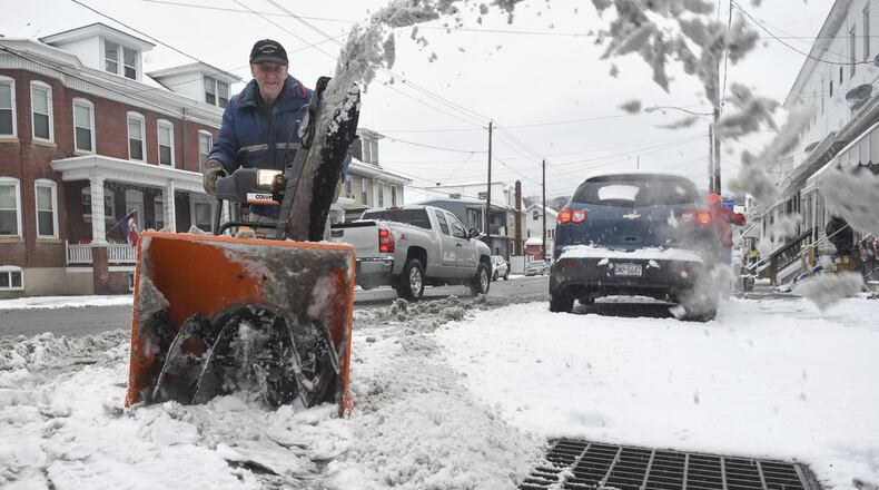 Lee Miller, Port Carbon, Pa., cuts through the snow on Coal Street in Port Carbon, Pa., on Thursday, Dec. 29, 2016. (Jacqueline Dormer/Republican-Herald via AP)