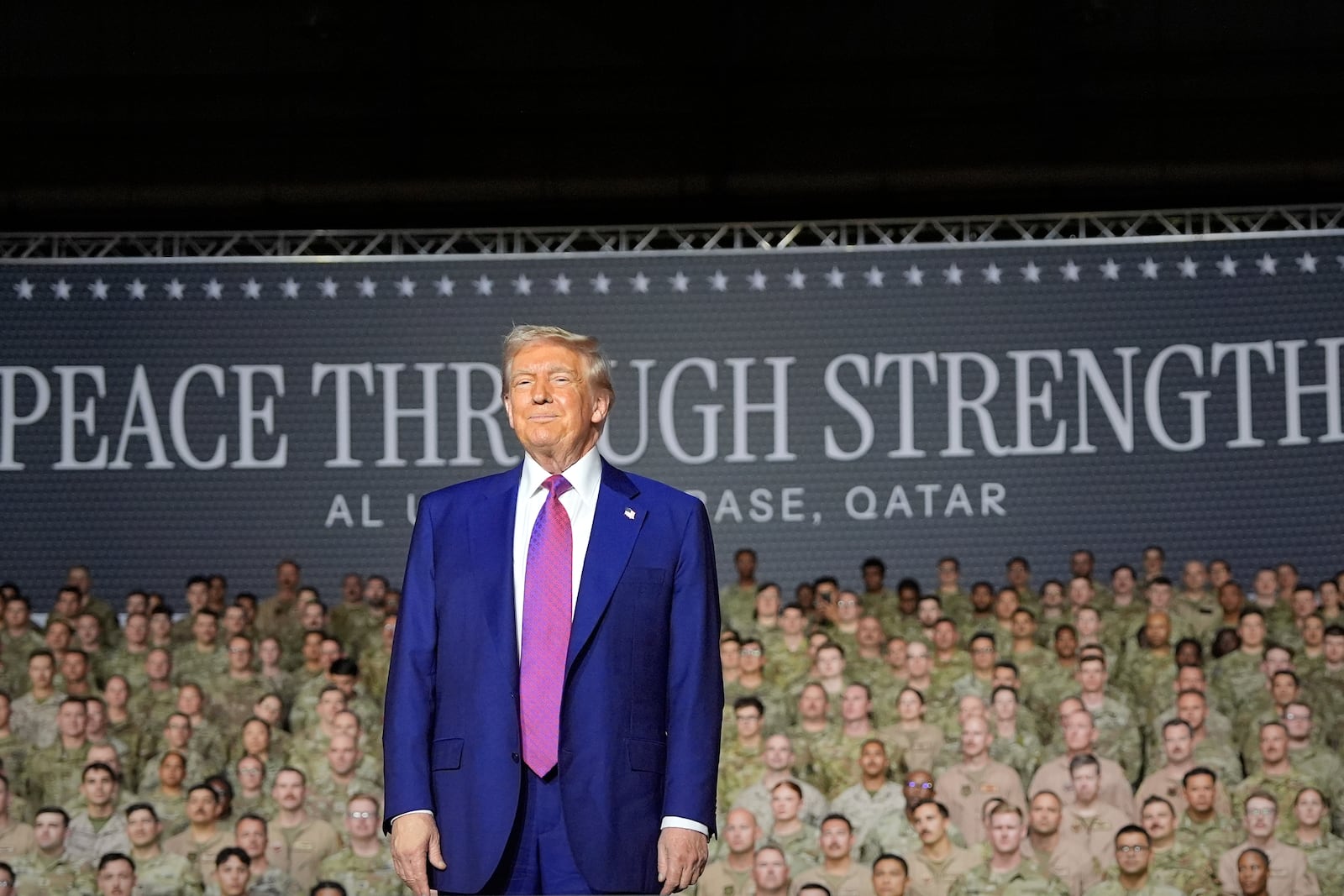 President Donald Trump stands on stage at the Al Udeid Air Base, Thursday, May 15, 2025, in Doha, Qatar. (AP Photo/Alex Brandon)