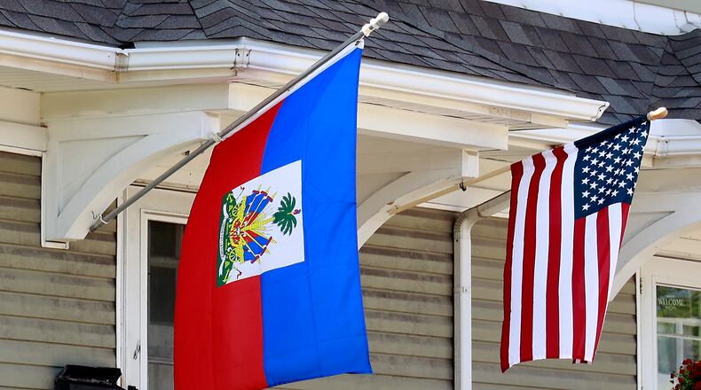A residence along North Limestone Street in Springfield was flying the Haitian flag alongside the American flag Wednesday, May 10, 2023. BILL LACKEY/STAFF