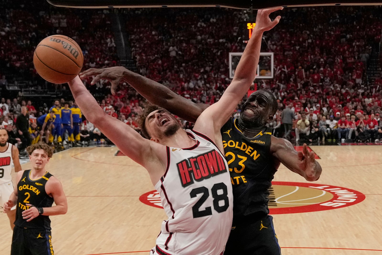 Houston Rockets' Alperen Sengun (28) goes up for a shot as Golden State Warriors' Draymond Green (23) defends during the second half of Game 7 of an NBA basketball first-round playoff series Sunday, May 4, 2025, in Houston. (AP Photo/Ashley Landis)