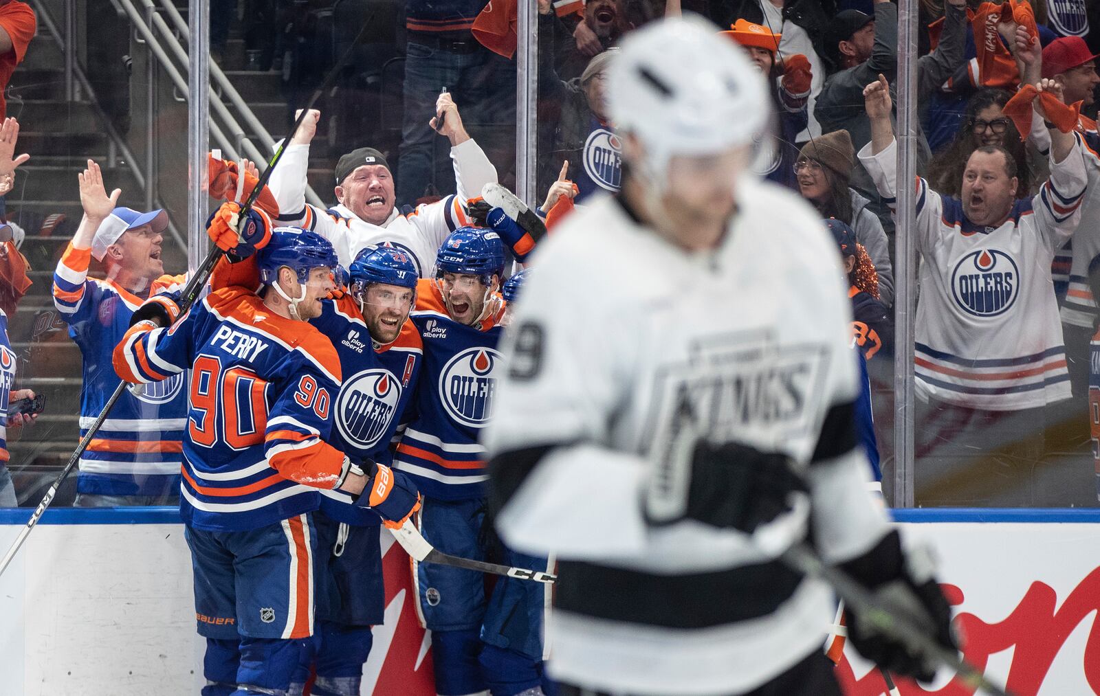 Edmonton Oilers' Corey Perry (90), Leon Draisaitl (29) and Evan Bouchard (2) celebrate the game-winning goal against the Los Angeles Kings in an overtime of an NHL playoff gamen in Edmonton on Sunday, April 27, 2025. (Jason Franson/The Canadian Press via AP)