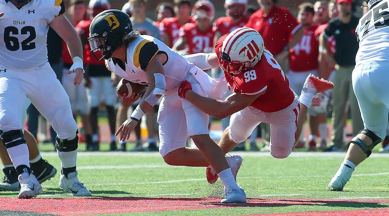 Wittenberg University's Conner Walls grabs DePauw University quarterback Chase Andries during their game on Sturday on Saturday afternoon at Edwards-Maurer Field in Springfield. DePauw won 17-14. CONTRIBUTED PHOTO BY MICHAEL COOPER