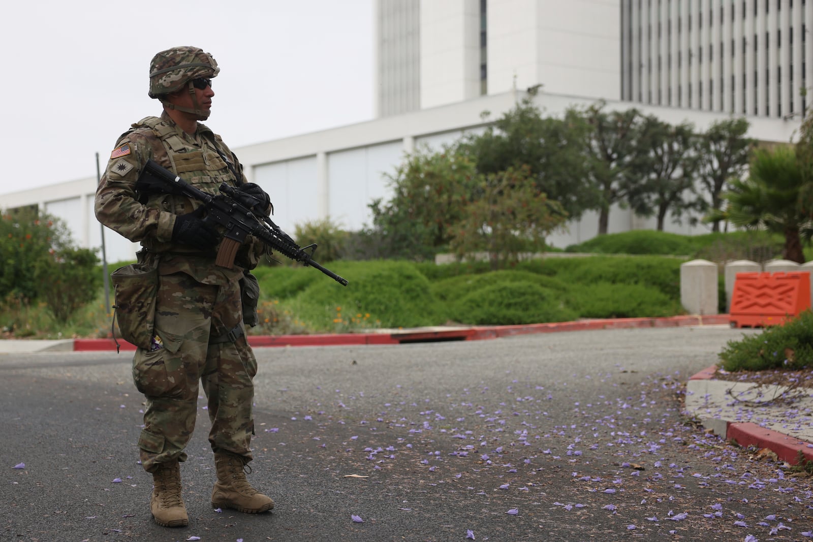 A member of the National Guard stands outside the Wishire Federal building on Thursday, June 12, 2025. (AP Photo/Etienne Laurent)
