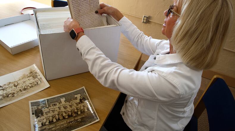 Susan Hamilton, looks over a box full of letters that her father, Floyd "Junie" Mitch, wrote to his family while in World War II. BILL LACKEY/STAFF