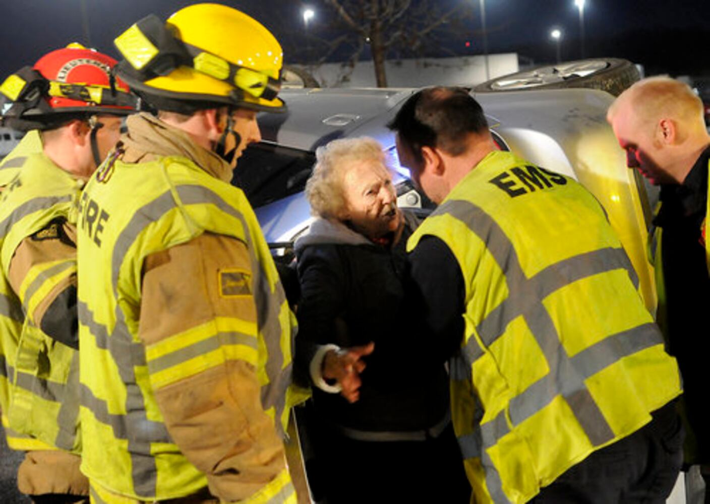 Car hits fire hydrant, turns on side