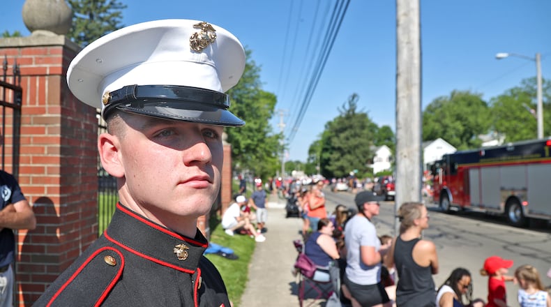 Marine Corp. Pvt. Nicholas Johnson watches the Springfield Memorial Day Parade in his dress uniform Monday, May 30, 2022. Thousands of people lined the parade route to watch the annual event. BILL LACKEY/STAFF