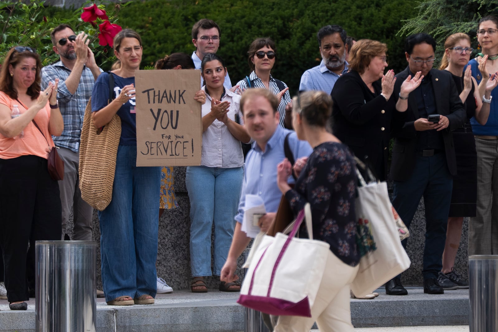 State Department employees applaud as their colleagues walk through the lobby of the State Department headquarters in the Harry S Truman Building, Friday, July 11, 2025, in Washington. (AP Photo/Manuel Balce Ceneta)