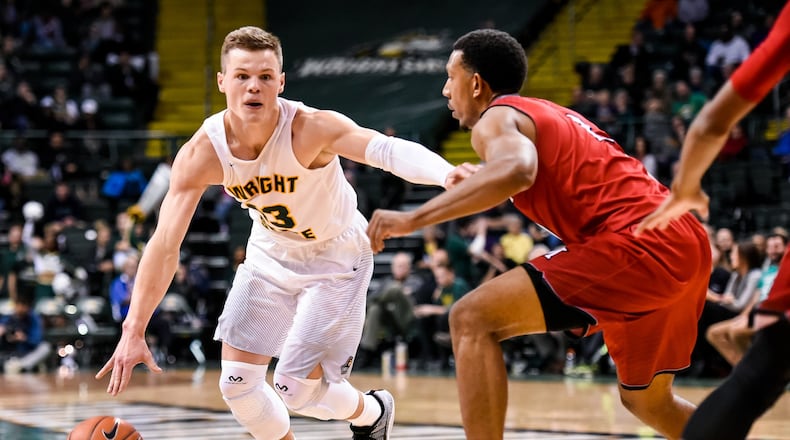 Wright State University’s Grant Benzinger dribbles to the hoop defended by Miami University’s Rod Mills, Jr. during their 89-87 win over Miami Tuesday, Nov. 15, 2016, at Wright State University’s Nutter Center in Fairborn. NICK GRAHAM/STAFF