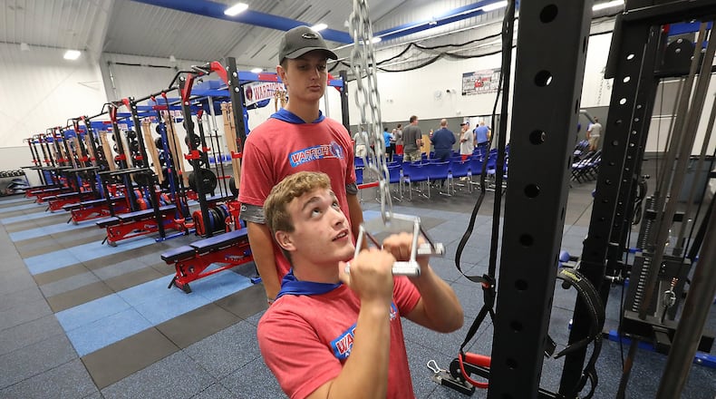 Nathan Snyder, seated, and Jake Suman try out the new workout equipment in the new athletic complex at Northwestern Schools Thursday evening. The new multi-million dollar complex was officially opened Thursday evening during a reception and open house. BILL LACKEY/STAFF