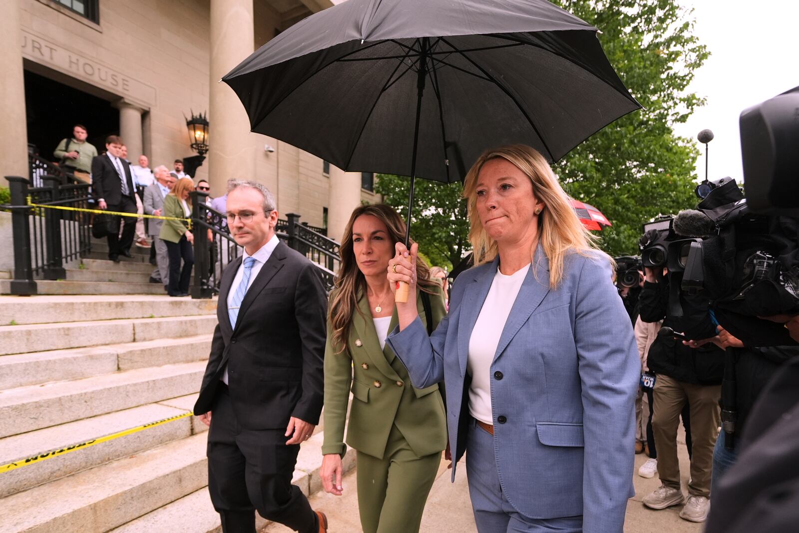 Karen Read, center, leaves Norfolk Superior Court for the day following jury deliberations at her trial, Tuesday, June 17, 2025, in Dedham, Mass. (AP Photo/Charles Krupa)