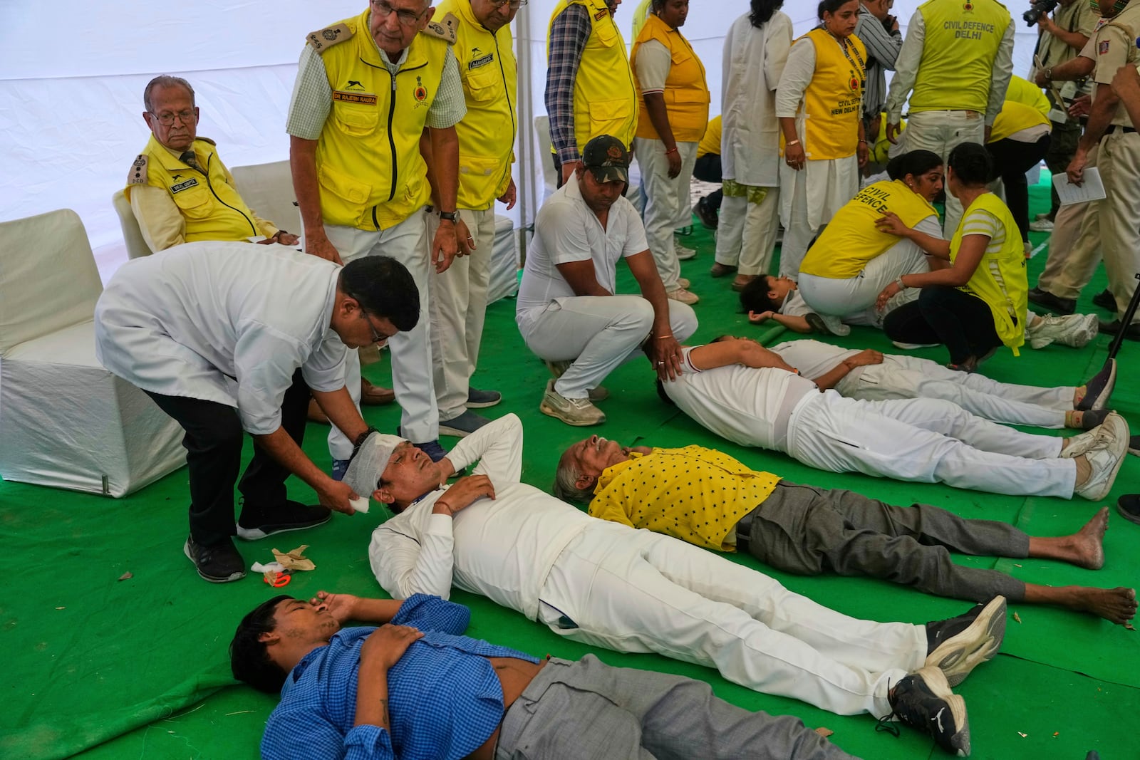 Civil defense members carry out a mock drill in a market to train civilians and security personnel to respond in case of attack, in New Delhi, India, Wednesday, May 7, 2025. (AP Photo/Manish Swarup)