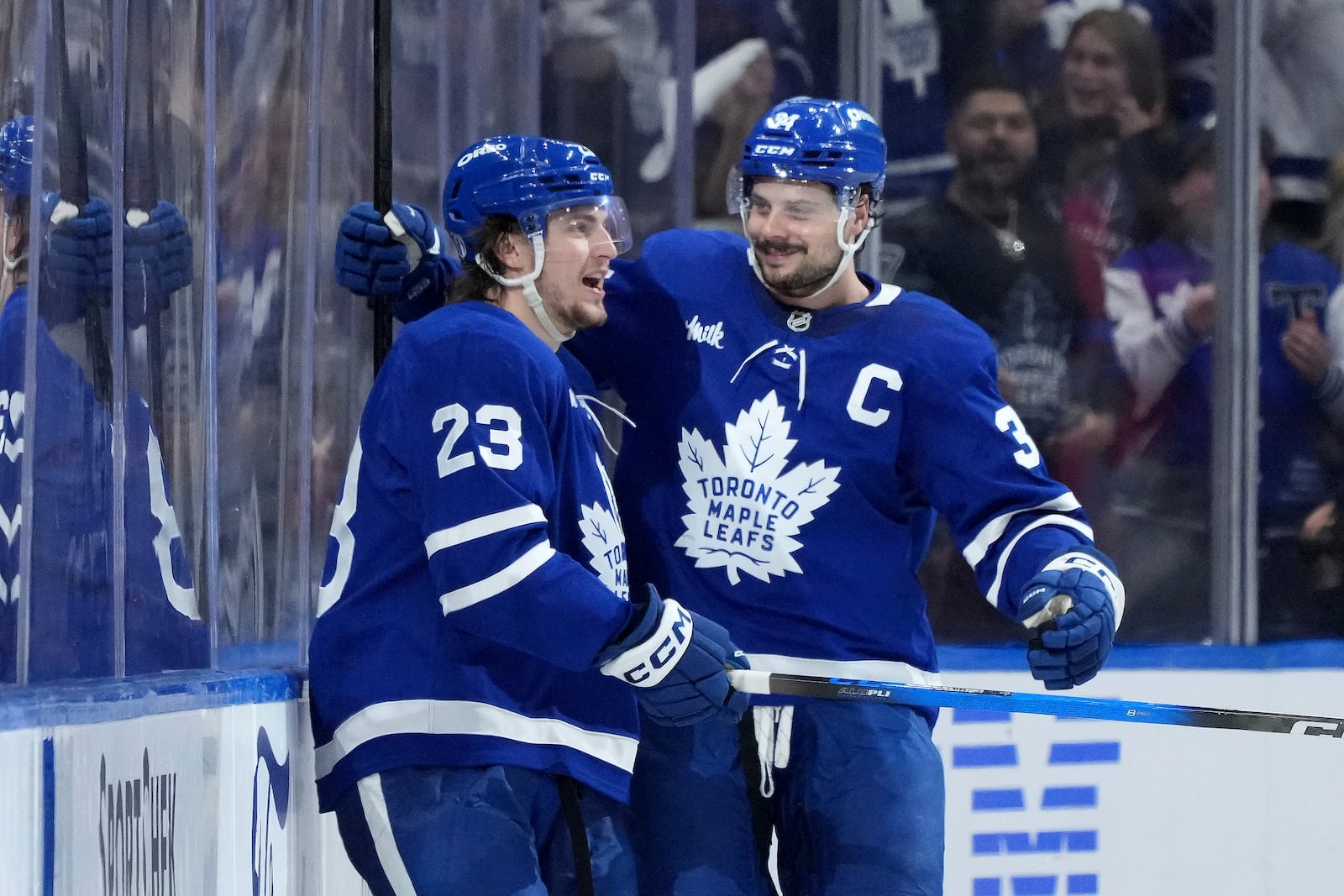 Toronto Maple Leafs forward Matthew Knies (23) celebrates after his goal with teammate Auston Matthews (34) during the third period of Game 1 in an NHL hockey second-round playoff series against the Florida Panthers in Toronto, Monday, May 5, 2025. (Nathan Denette/The Canadian Press via AP)