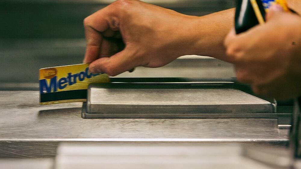 FILE - A subway rider swipes his MetroCard in a turnstile as he enters the 34th St. subway station, July 23, 2007, in New York. (AP Photo/Mary Altaffer, File)