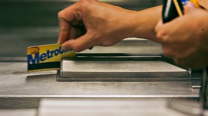 FILE - A subway rider swipes his MetroCard in a turnstile as he enters the 34th St. subway station, July 23, 2007, in New York. (AP Photo/Mary Altaffer, File)