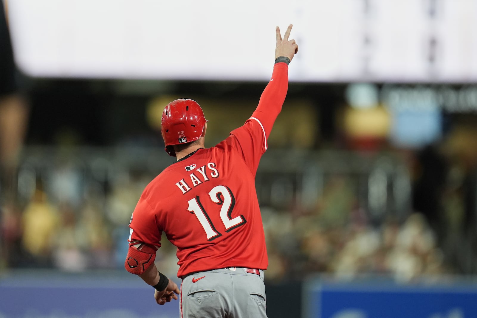 Cincinnati Reds' Austin Hays (12) celebrates after hitting a home run during the sixth inning of a baseball game against the San Diego Padres Monday, Sept. 8, 2025, in San Diego. (AP Photo/Gregory Bull)