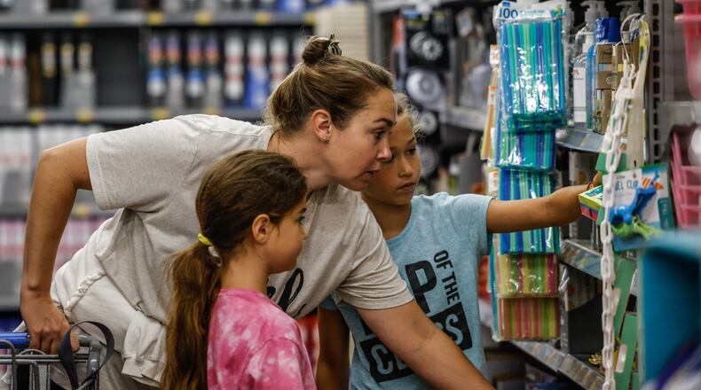Natalie Folino and her two daughters, Bianca, left and Genevieve on the right shop for back to school supplies at the Super Walmart on Wilmington Pike .Ohio’s sales tax holiday on school supplies, instructional material and clothes runs from noon Aug. 5 to 11:59 p.m. Aug. 7. Exempt from sales and use tax during the holiday are items of clothing priced at $75 or less, items of school supplies priced at $20 or less and items of school instructional material priced at $20 or less. JIM NOELKER/STAFF