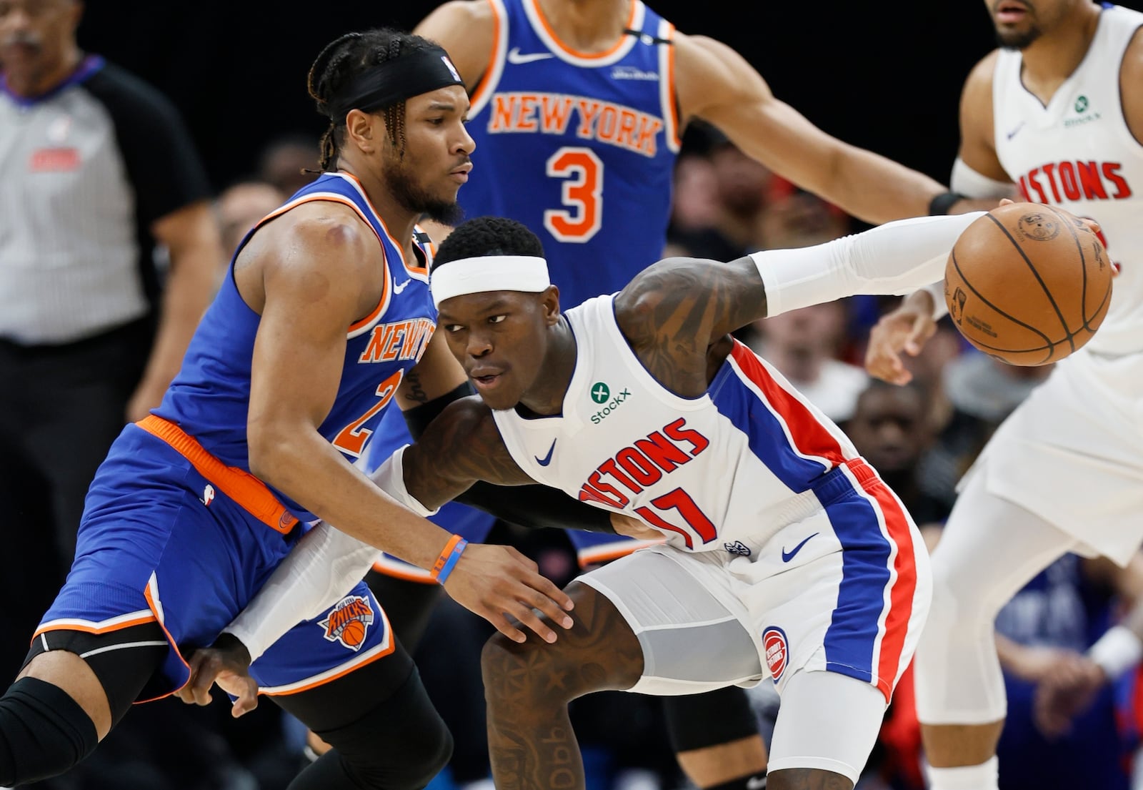 Detroit Pistons guard Dennis Schroder (17) drives against New York Knicks guard Miles McBride (2) during the first half of Game 6 of an NBA basketball first-round playoff series Thursday, May 1, 2025, in Detroit. (AP Photo/Duane Burleson)