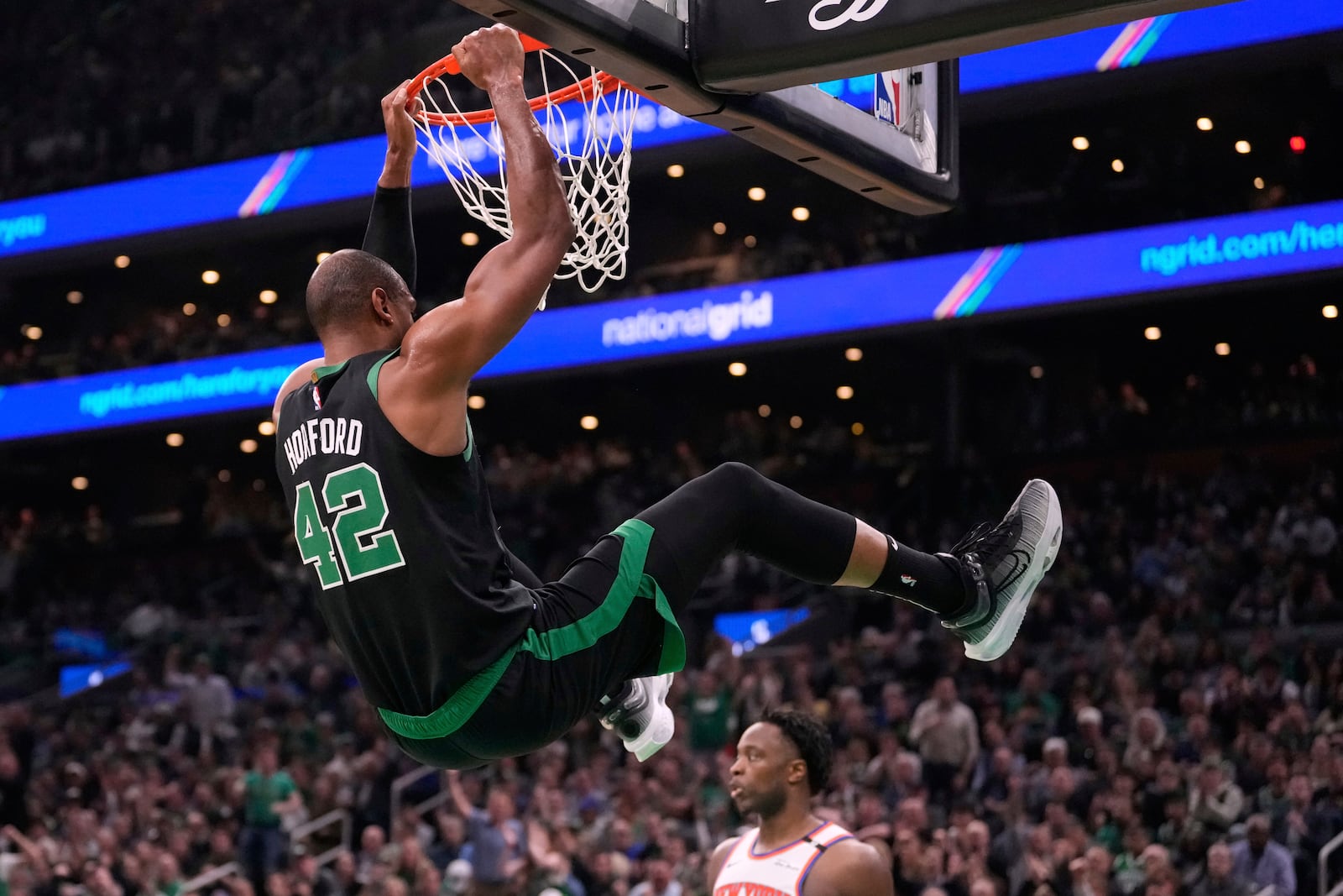 Boston Celtics center Al Horford (42) dunks against the New York Knicks during the first half of Game 5 of an NBA basketball second-round playoff series, Wednesday, May 14, 2025, in Boston. (AP Photo/Charles Krupa)