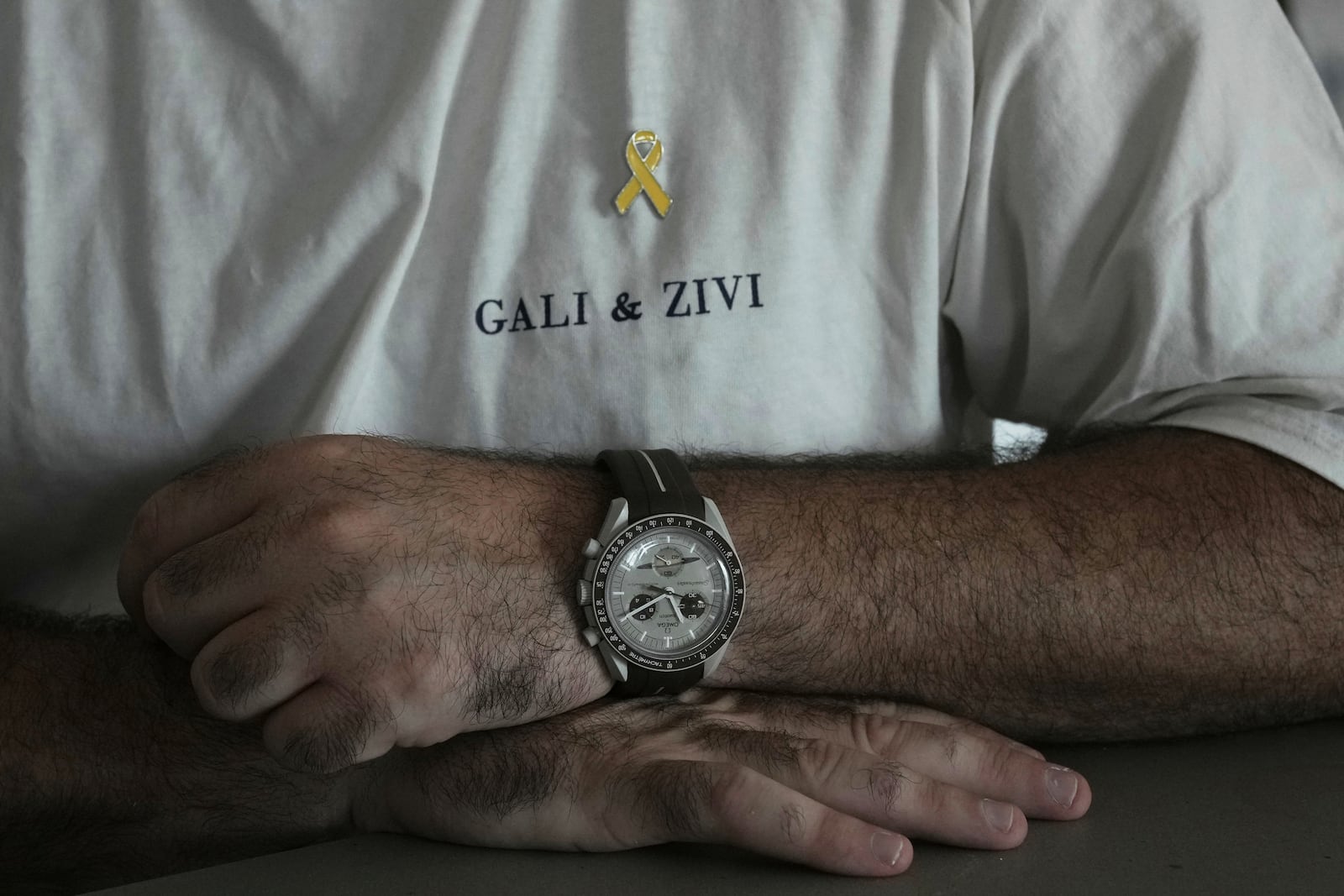 Liran Berman, brother of twins Ziv and Gali Berman, who were abducted by militants on Oct. 7, 2023, wears a T-shirt with their names in Or Akiva, Israel, Wednesday, June 25, 2025. (AP Photo/Maya Alleruzzo)