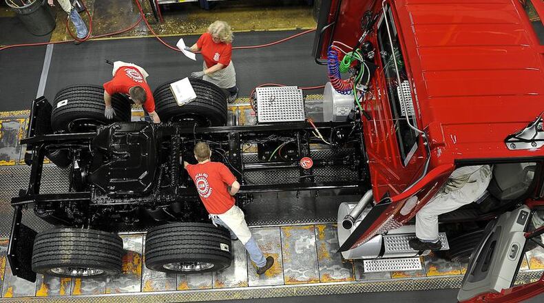 Navistar employees build a truck on the assembly line at the Springfield plant in 2017. Local union members at Navistar were asked to vote on a tentative contract extension agreement on Wednesday.