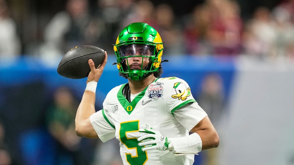 Oregon quarterback Dante Moore (5) passes against Indiana during the second half of the Peach Bowl NCAA college football playoff semifinal, Friday, Jan. 9, 2026, in Atlanta. (AP Photo/Brynn Anderson)