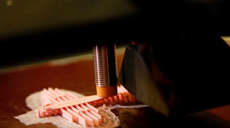 A 3D printer creates a small airplane. LISA POWELL / STAFF
