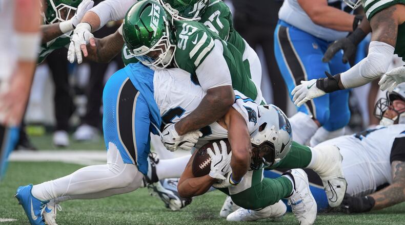 New York Jets defensive tackle Quinnen Williams (95) tackles Carolina Panthers running back Chuba Hubbard (30) during the fourth quarter of an NFL football game, Sunday, Oct. 19, 2025, in East Rutherford, N.J. (AP Photo/Seth Wenig)