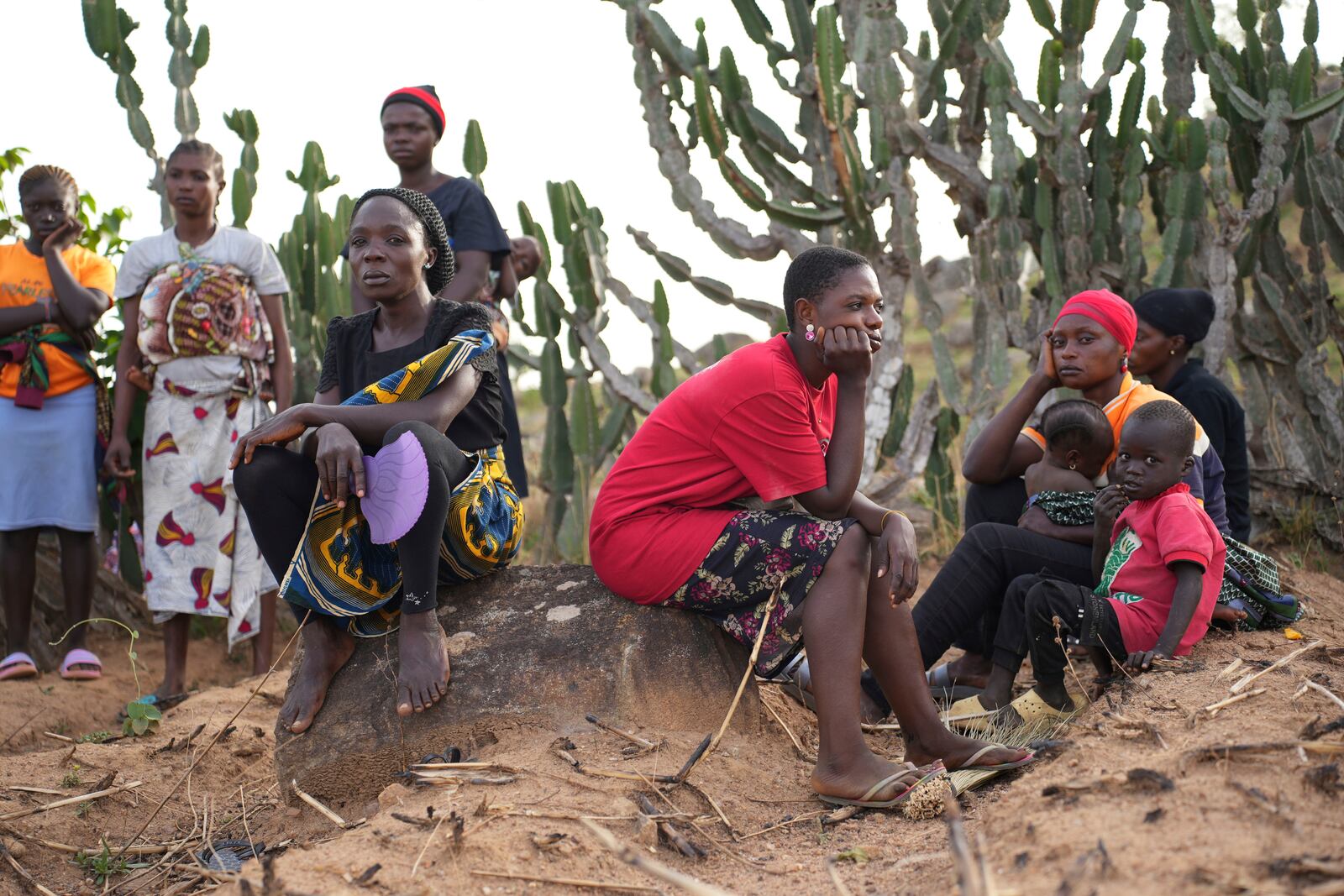 Women mourn the death of a family member following an attack by gunmen in the Zike farming community in north-central Nigeria, Tuesday, April 15, 2025. (AP Photo/Samson Omale)