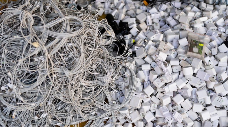 FILE - Used charging cables and power adapters are piled up at a shop in Nhat Tao market, the largest informal recycling market in Ho Chi Minh City, Vietnam, Jan. 28, 2024. (AP Photo/Jae C. Hong, File)