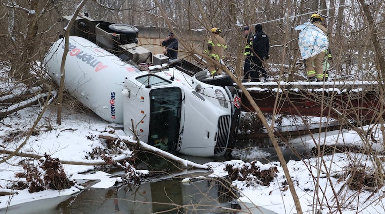 A liquid propane tanker truck slid off a bridge into a creek while it was being towed from private property Monday, Jan. 24, 2022, in the 1000 block of Shrine Road in Springfield Twp. BILL LACKEY/STAFF