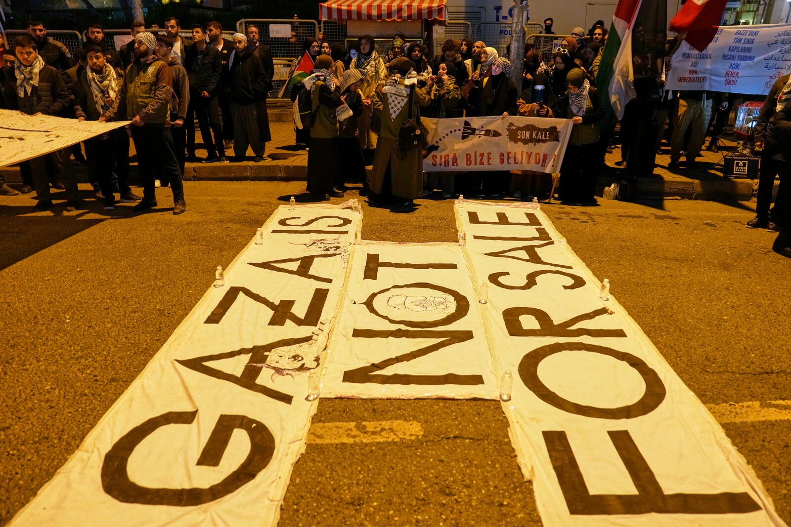 People protest against an Israeli drone attack on a vessel carrying aid to Gaza in international waters off Malta, outside the Israeli consulate in Istanbul, Friday, May 2, 2025. (AP Photo/Khalil Hamra)