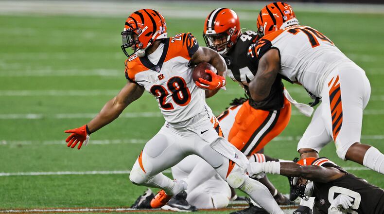Cincinnati Bengals running back Joe Mixon (28) breaks free from Cleveland Browns cornerback Terrance Mitchell (39) during the first half of an NFL football game, Thursday, Sept. 17, 2020, in Cleveland. (AP Photo/Ron Schwane)