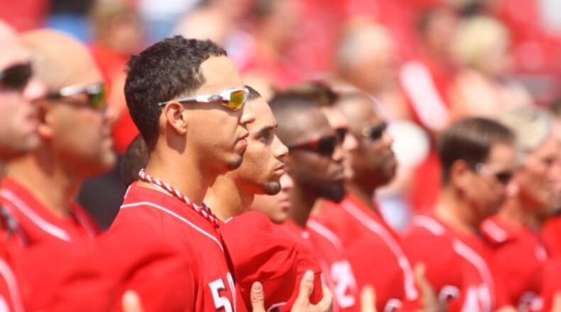 The Reds stand for the national anthem on Monday. David Jablonski/Staff
