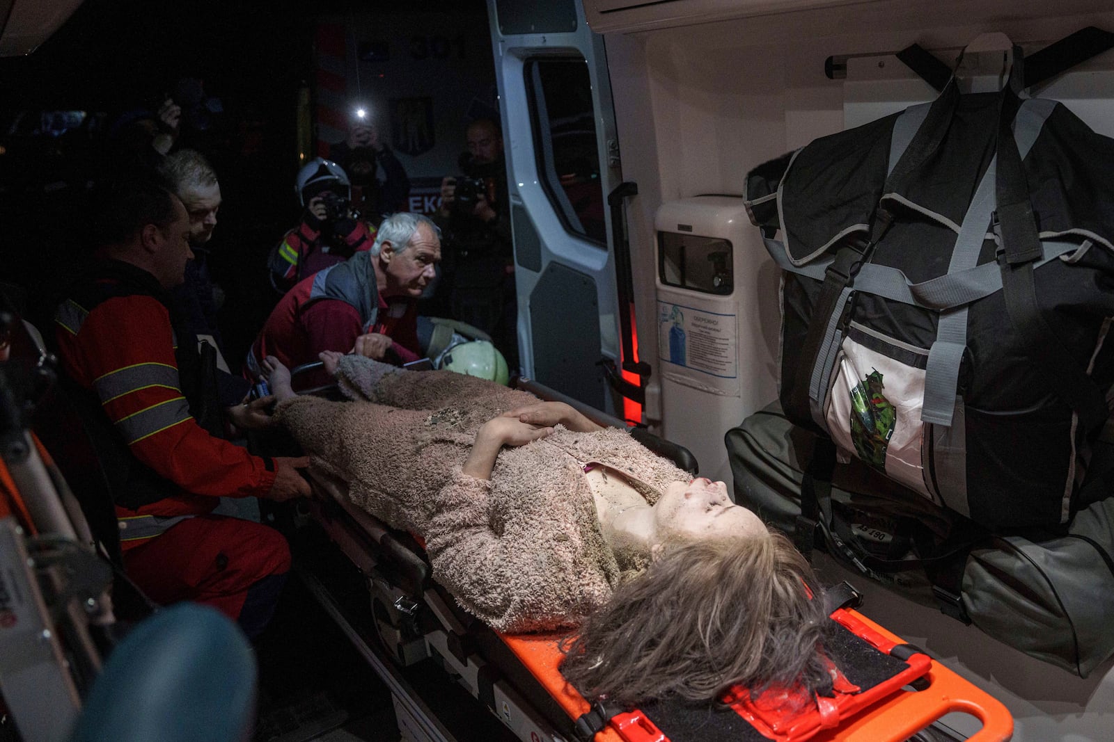 Medics tend to an injured woman in an ambulance near a house destroyed by a Russian airstrike in a residential neighbourhood in Kyiv, Ukraine, on Thursday, April 24, 2025. (AP Photo/Evgeniy Maloletka)