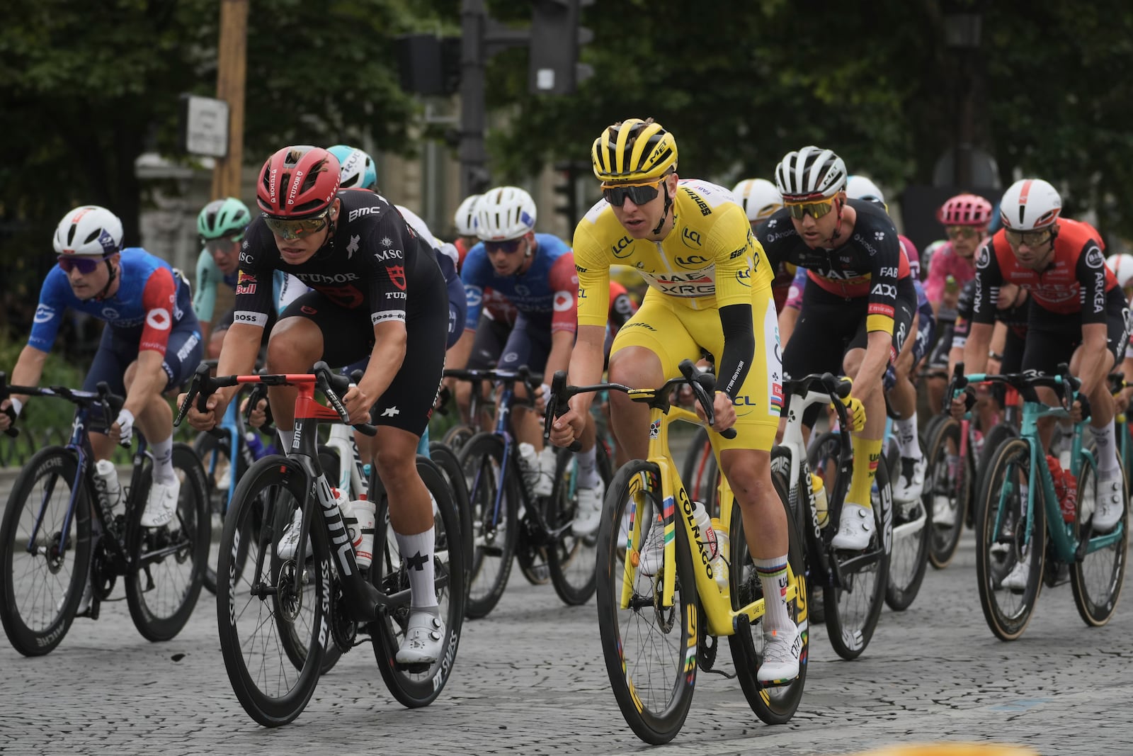 Slovenia's Tadej Pogacar, wearing the overall leader's yellow jersey, rides in the pack during the twenty-first stage of the Tour de France cycling race over 132.3 kilometers (82.1 miles) with start in Mantes-la-Ville and finish on the Champs-Elysees in Paris, France, Sunday, July 27, 2025. (AP Photo/Thibault Camus)