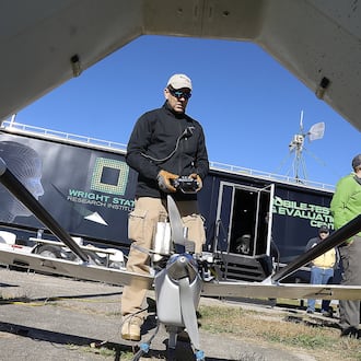 In this 2017 file photo, Dave Malek performed a safety check on a drone before flight-testing for the Air Force Research Lab at Springfield Beckley Municipal Airport. Bill Lackey/Staff