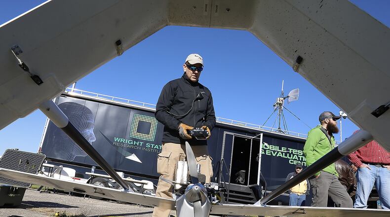 Dave Malek performs a safety check on a UAV before it takes off for one of the Air Force Research Labratory’s test flights at Springfield Beckley Municipal Airport. Bill Lackey/Staff