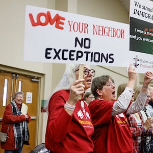 Audience members sing along to praise songs and hold pro-immigration signs during Here We Stand: Faith Leaders for Immigration Justice & Family Unity at St. John Missionary Baptist Church on Monday, Feb. 2, 2026, in Springfield. Pastors, faith leaders and community members gathered to pray and call for the extension of Temporary Protected Status which is scheduled to expire on Tuesday, Feb. 3, 2026. JOSEPH COOKE/STAFF