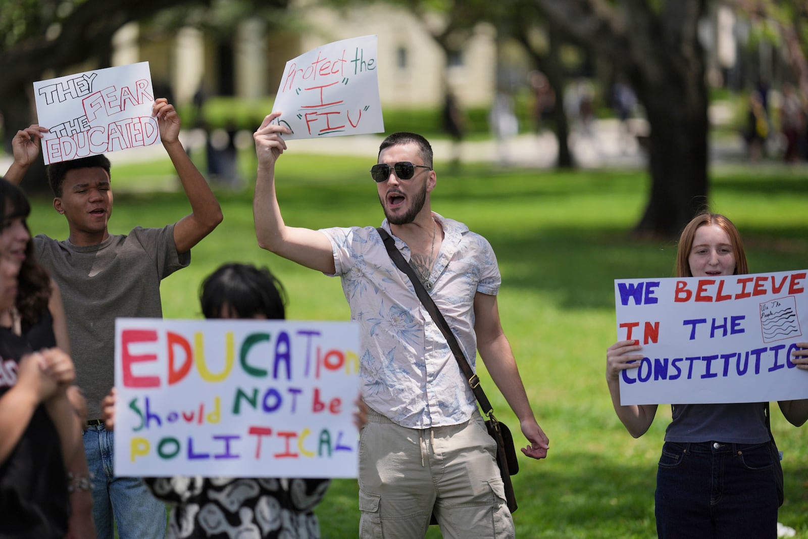 FILE - A group of Florida International University students protest against cuts in federal funding and an agreement by campus police to partner with Immigration and Customs Enforcement, on the FIU campus on a day of protests around the country in support of higher education, April 17, 2025, in Miami. (AP Photo/Rebecca Blackwell, File)