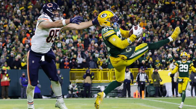 Green Bay Packers cornerback Keisean Nixon (25) intercepts a pass against Chicago Bears tight end Cole Kmet (85) during the second half of an NFL football game Sunday, Dec. 7, 2025, in Green Bay, Wis. (AP Photo/Matt Ludtke)