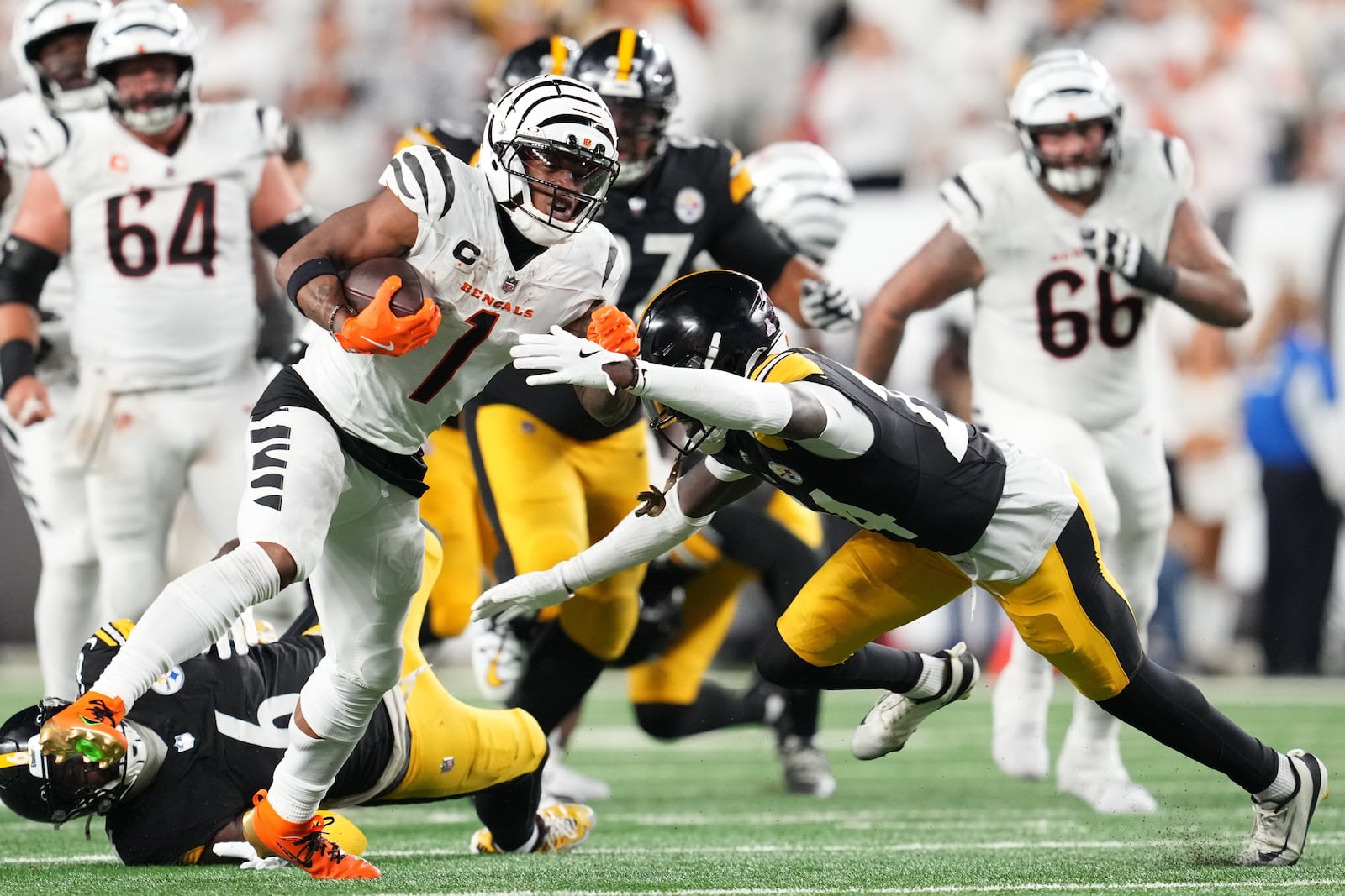 Cincinnati Bengals wide receiver Ja'Marr Chase (1) gets past Pittsburgh Steelers cornerback Joey Porter Jr. (24) for a first down after taking a pass from quarterback Joe Flacco during the second half of an NFL football game in Cincinnati Thursday, Oct. 16, 2025. (AP Photo/Jeff Dean)