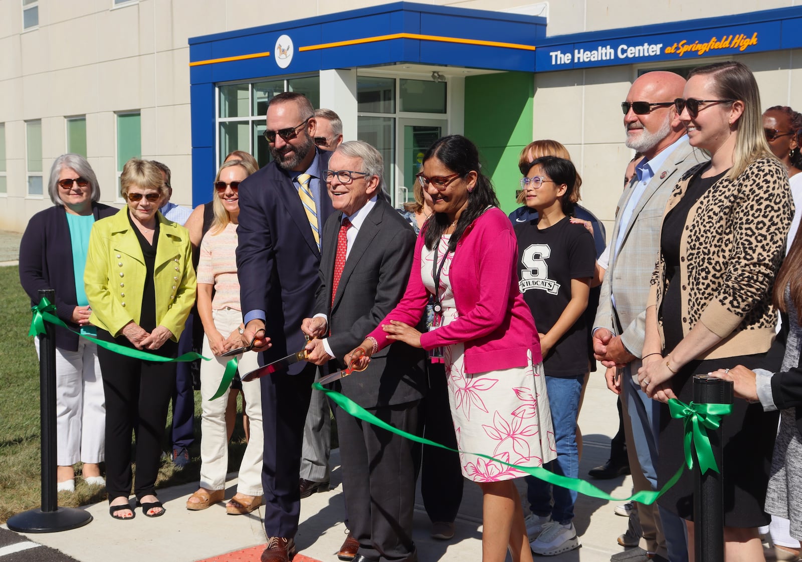 Springfield City Schools Superintendent Bob Hill (left), Ohio Gov. Mike DeWine and Rocking Horse Community Health Center CEO Dr. Yamini Teegala cut the ribbon at Springfield's new School Based Health Center Monday, Aug. 12, 2024. JESSICA OROZCO/STAFF