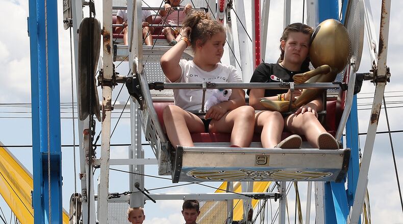 Riders wait for people to get on the ferris wheel Tuesday at the Clark County Fair, where attendance was up by 4,000 visitors. BILL LACKEY/STAFF