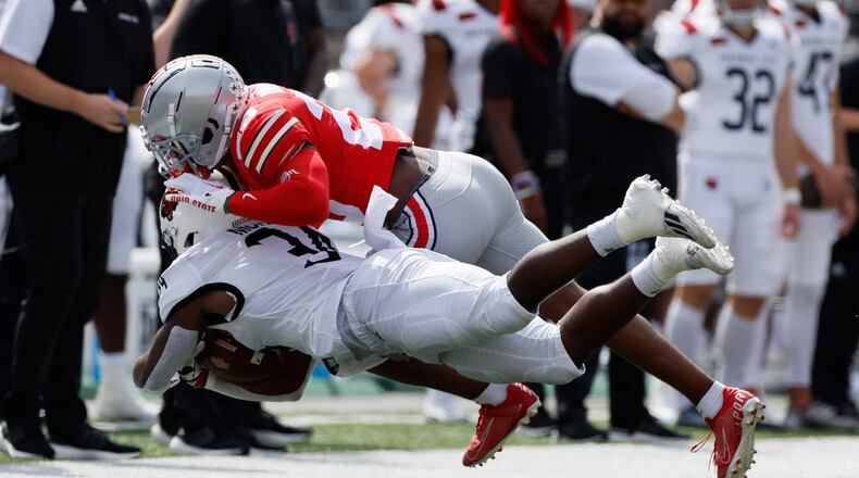 Ohio State defensive back Cameron Brown, top, tackles Arkansas State running back Marcel Murray during the first half of an NCAA college football game Saturday, Sept. 10, 2022, in Columbus, Ohio. (AP Photo/Jay LaPrete)