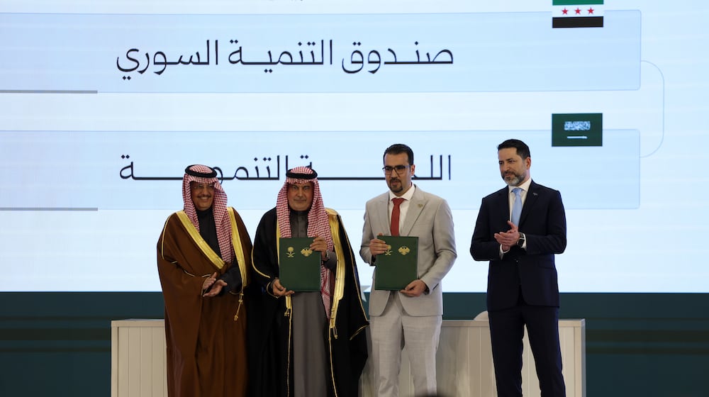 Officials pose after signing a framework agreement for developmental cooperation and the launch of 45 development initiatives between the Syrian Development Fund and Saudi Arabia's Development Committee at the People's Palace in Damascus, Syria, Saturday, Feb. 7, 2026. (AP Photo/Ghaith Alsayed)