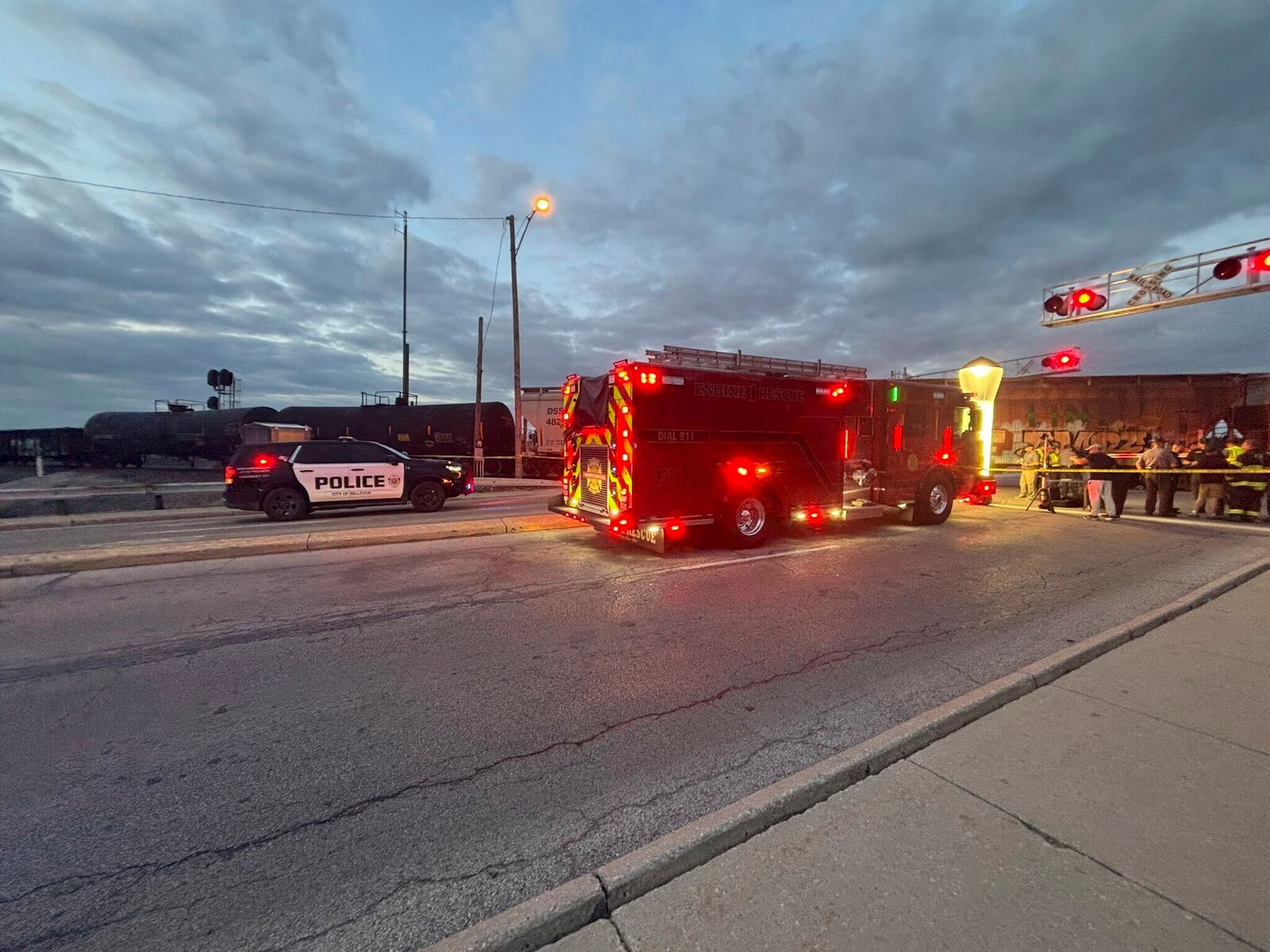 In this photo provided by Emerson Young, first responders are at the scene where a train sits idle on tracks after striking multiple pedestrians Sunday evening, May 18, 2025, in Fremont, Ohio. (Emerson Young via AP)