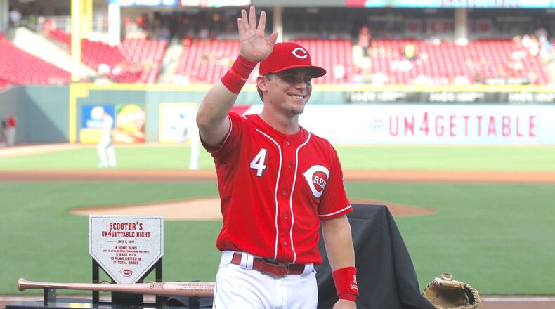 The Reds’ Scooter Gennett waves to the crowd during a pregame ceremony honoring him before a game against the Dodgers on Friday, June 16, 2017, at Great American Ball Park in Cincinnati. David Jablonski/Staff
