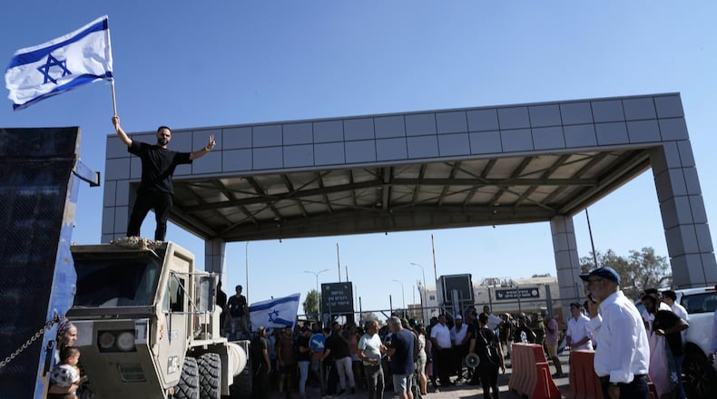 FILE - A protester waves the Israeli national flag in support of soldiers being questioned for detainee abuse, outside of the Sde Teiman military base on July 29, 2024. (AP Photo/Tsafrir Abayov, File)