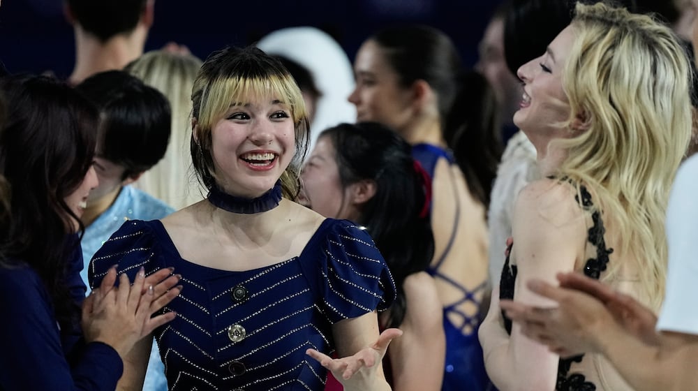 Alysa Liu of the United States, center, reacts with other athletes after performing in the figure skating exhibition at the 2026 Winter Olympics, in Milan, Italy, Saturday, Feb. 21, 2026. (AP Photo/Ashley Landis)
