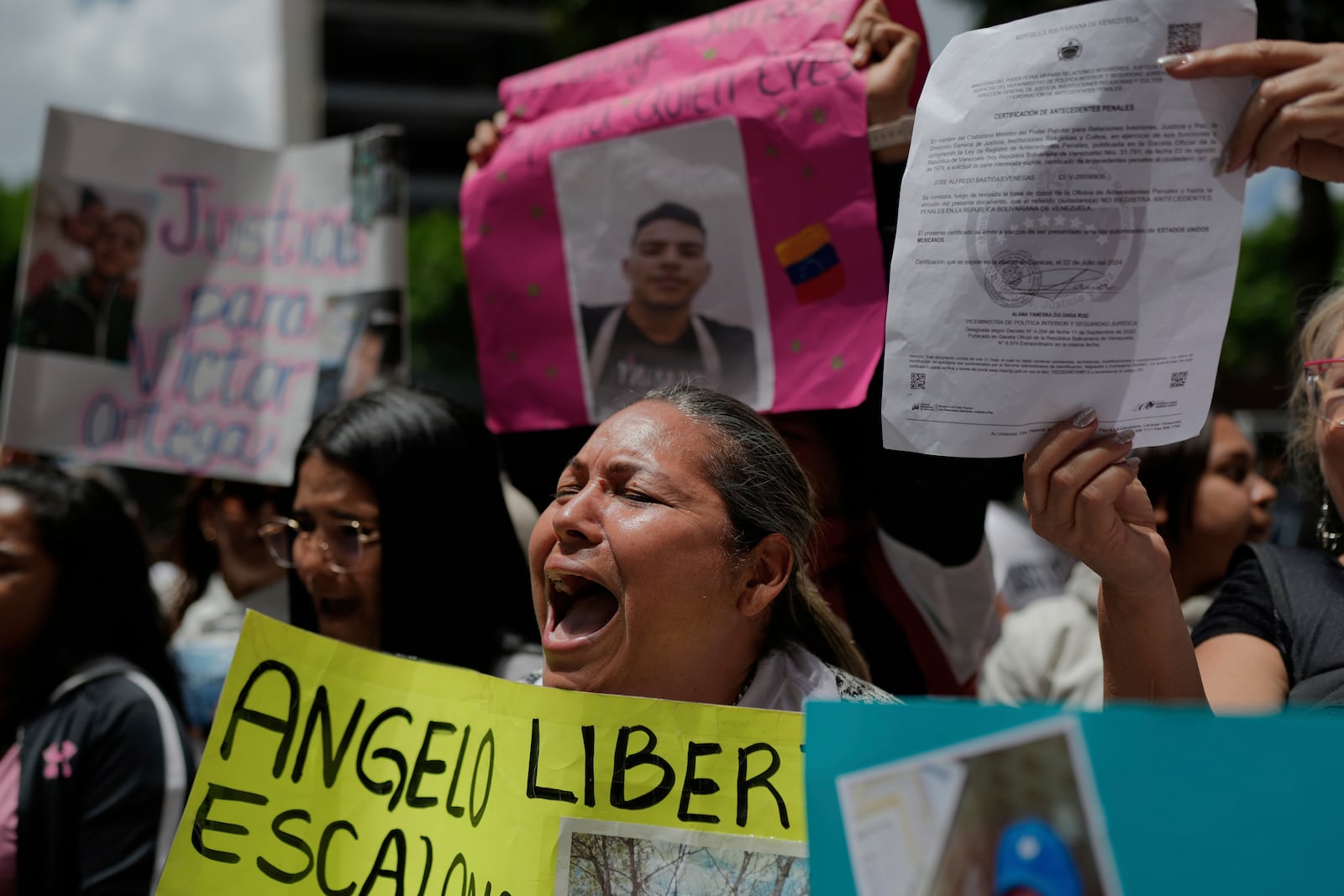 The relatives of Venezuelan migrants in the U.S. who were flown to a prison in El Salvador by the U.S. government who alleged they were members of the Tren de Aragua gang, protest outside of the United Nations building in Caracas, Venezuela, Wednesday, April 9, 2025. (AP Photo/Ariana Cubillos)